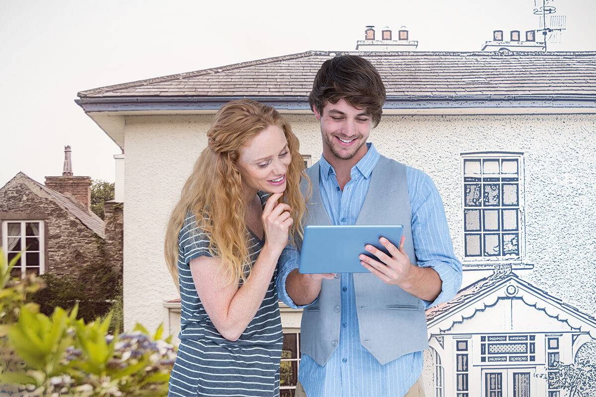 Couple holding tablet in front of imaginary home